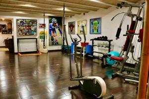 a gym with several exercise equipment in a room at Cas Coix Jacuzzi, gym & pool in Biniali