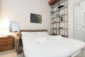 a bedroom with a white bed with towels on it at PrimoPiano - Sant' Arnaldo in Milan