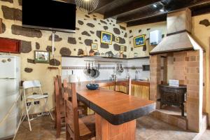a kitchen with a wooden table and a stove at Ancana in Vega de San Mateo