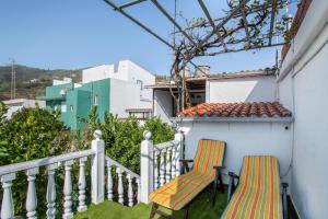 two chairs sitting on the balcony of a house at Ancana in Vega de San Mateo