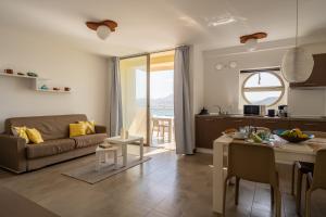 a kitchen and living room with a couch and a table at Las Rochas Mindelo Aparthotel in Mindelo