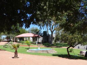 a park with a fountain and a gazebo at Eden Chalets in Windhoek +16 photos