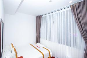 Postel nebo postele na pokoji v ubytování The Rice Sen Ốc 191 - 226 Bùi Viện