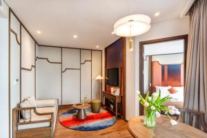 a living room with a table and a dining room at Mandala Chambayy Mũi Né TNRSS in Mui Ne