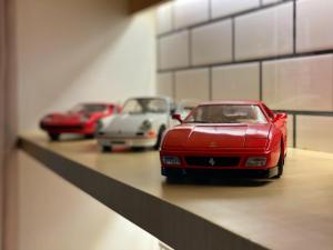three toy cars are sitting on a shelf at Ploy Mountain View Pool Villa in Ban Thai Thai