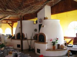 a room with a room with a table and a room with a room at La Curia Panzió in Dunaszeg