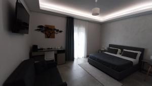 a bedroom with a bed and a desk and a television at B&B Campo Sportivo in Taurianova