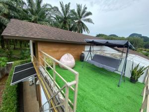 a backyard with a tent and green grass at Ploy Mountain View Pool Villa in Ban Thai Thai