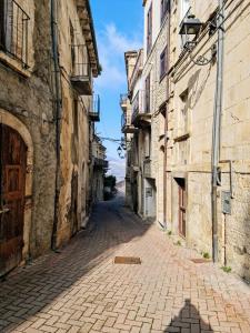 an empty street in an alley with buildings at Authentic Village Townhouse with Independant Apartment in Chieti