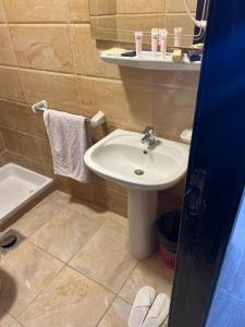a bathroom with a sink and a bath tub at La mer Hotel in Alexandria +8 photos