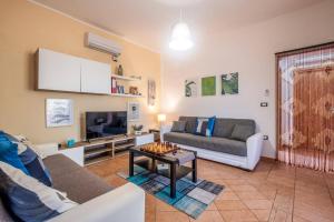 a living room with a couch and a table at Villa Aranceto by Villa Plus in San Vito dei Normanni