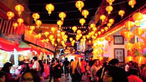 a crowd of people walking down a street with lanterns at Luxurious &cozy apartment with pool and gym in Sydney CBD in Sydney +73 photos