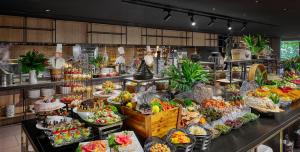 a buffet line with many different types of food at PARKROYAL Penang Resort in Batu Ferringhi