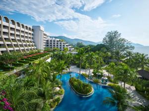 an aerial view of a resort with blue water and palm trees at PARKROYAL Penang Resort in Batu Ferringhi