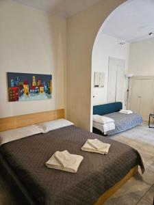 a bedroom with two beds with towels on them at La palazzina al LINGOTTO in Turin