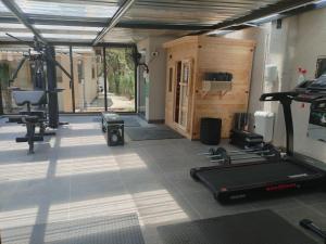 a gym with treadmills and equipment in a room at Luyana guesthouse in Kroonstad