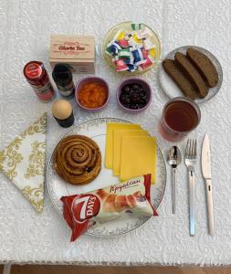 a table topped with a plate of food with cookies at Friends Premium HOSTEL in Baku +4 photos