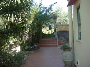 a porch of a house with a vase of flowers at B&B Villa Ursa Major in Vico Equense