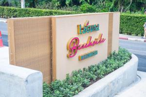 a sign for a restaurant on the side of a street at Laguna Beachside residences apartamens, walking distance to the sea in Bang Tao Beach