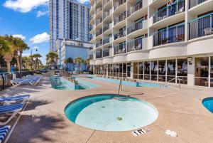 a swimming pool in front of a building at Boardwalk Resort Beachfront Condos in Myrtle Beach