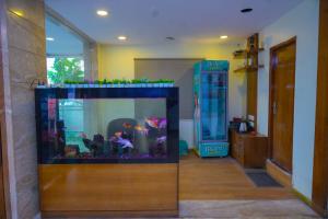 a large aquarium in a room with a phone booth at Octave Hotel AM Garden in Bangalore