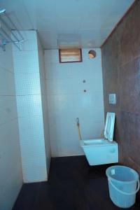 a bathroom with a toilet and a sink at Octave Hotel AM Garden in Bangalore +17 photos
