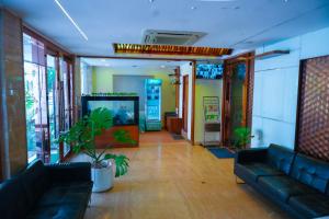 a waiting room with couches and a video game at Octave Hotel AM Garden in Bangalore