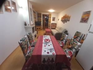a living room with a table and a couch at Апартамент 9 in Pamporovo +5 photos