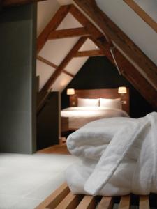a bedroom with a bed with white sheets at Texel Suites in Oudeschild