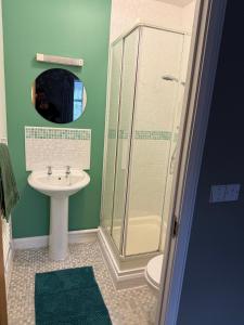 a bathroom with a shower and a sink at Spacious Contractor House for Families, Groups, and Free Parking in Yeovil