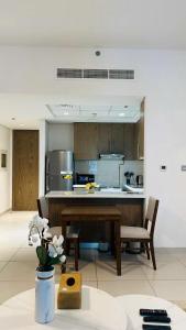a kitchen with a table and some chairs in a room at MontRose residence Tower A 1BR Apartment in Dubai