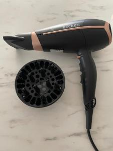 a hair dryer sitting on top of a counter at Sunny Seaview Modern apt - pool and beach access in Taurito