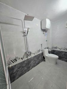 a bathroom with a toilet and a shower at Long tearm rental-Whole house with swimming pool in Kỳ Vĩ