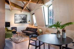 a living room with a table and a couch at V Lofts in Amsterdam