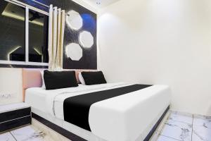a bedroom with a white bed and a window at Hotel O SR & Guest House 2 in Sakardarā