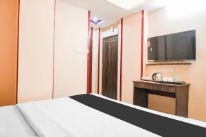 Postel nebo postele na pokoji v ubytování Super Hotel O MOHAR KUNJHA
