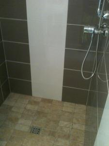 a bathroom with a shower with a tile floor at Gîte d'étape d'Aurouses in Die