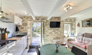 a kitchen and living room with a couch and a table at Ty Chann Rouz in Ile de Sein