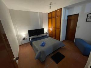 a bedroom with a bed with a blue object on it at Acogedor apartamento, San Gil, Santander in San Gil