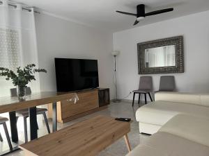 a living room with a couch and a tv at Iberia home beach in Águilas