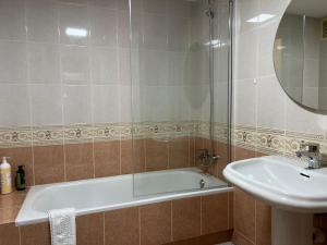 a bathroom with a bath tub and a sink at Iberia home beach in Águilas +12 photos