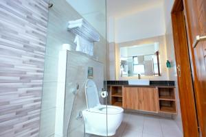 a bathroom with a toilet and a sink at Jumeirah Palms Resort in Mombasa +22 photos