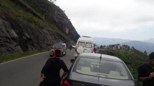 a group of cars driving down a road with people at The Tea Leaf Cottage in Munnar +1 photo