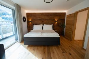a bedroom with a bed and a large window at New Penthouse near Sölden - Runhof Top11 in Längenfeld +19 photos