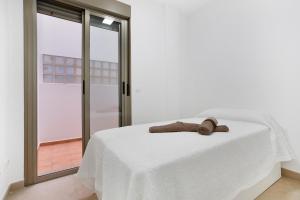 a white bed with two towels on top of it at Casa Castilla in Puerto del Rosario
