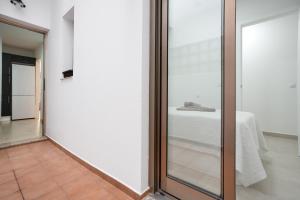 a glass door leading into a room with a bed at Casa Castilla in Puerto del Rosario +19 photos