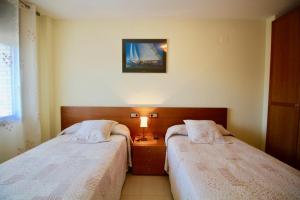 Ένα ή περισσότερα κρεβάτια σε δωμάτιο στο Apartment Levante +22 φωτογραφίες