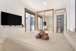 a teddy bear laying on top of a bed at Casa Castilla in Puerto del Rosario