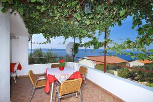 a table and chairs on a balcony with a view at Pisak holiday homes in Pisak