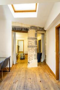 an open living room with a brick fireplace and a skylight at Cosy & Duplex - Appartements au coeur de la vieille Ville in Clermont-Ferrand +62 photos